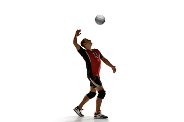 Image showing Young caucasian volleyball player placticing isolated on white background