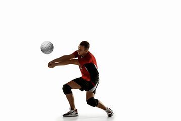 Image showing Young caucasian volleyball player placticing isolated on white background