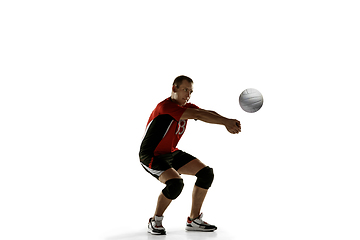 Image showing Young caucasian volleyball player placticing isolated on white background