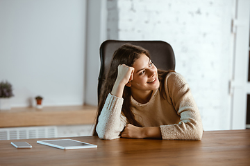 Image showing Portrait of young caucasian girl in casual clothes looks dreamful and happy