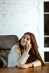 Image showing Portrait of young caucasian girl in casual clothes looks dreamful and happy