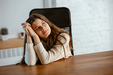 Image showing Portrait of young caucasian girl in casual clothes looks dreamful and happy