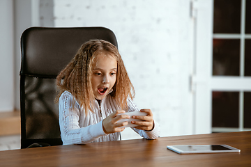 Image showing Portrait of young caucasian girl in casual clothes looks dreamful and happy