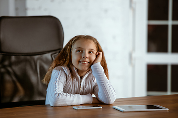 Image showing Portrait of young caucasian girl in casual clothes looks dreamful and happy