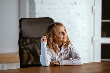 Image showing Portrait of young caucasian girl in casual clothes looks dreamful and happy