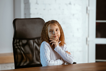 Image showing Portrait of young caucasian girl in casual clothes looks dreamful and happy