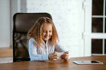 Image showing Portrait of young caucasian girl in casual clothes looks dreamful and happy