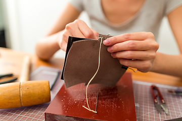 Image showing Woman making leather