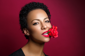 Image showing beautiful woman with rose in mouth