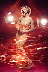 Image showing beautiful girl in evening dress surrounded by light