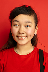 Image showing Asian teenager\'s close up portrait isolated on red studio background