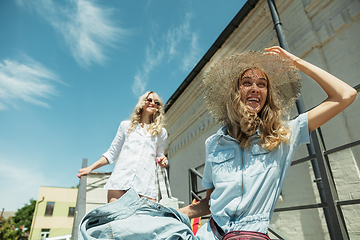 Image showing Young lesbian\'s couple preparing for vacation trip on the car in sunny day