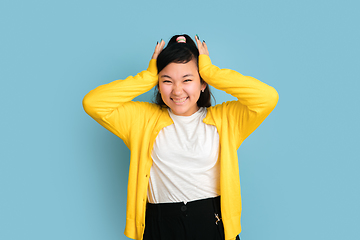 Image showing Asian teenager\'s portrait isolated on blue studio background