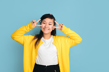 Image showing Asian teenager\'s portrait isolated on blue studio background