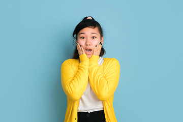 Image showing Asian teenager\'s portrait isolated on blue studio background