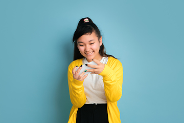 Image showing Asian teenager\'s portrait isolated on blue studio background