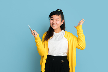 Image showing Asian teenager\'s portrait isolated on blue studio background