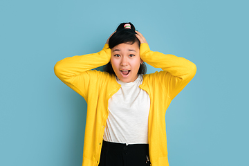 Image showing Asian teenager\'s portrait isolated on blue studio background