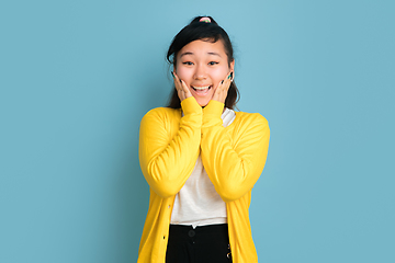 Image showing Asian teenager\'s portrait isolated on blue studio background