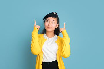 Image showing Asian teenager\'s portrait isolated on blue studio background