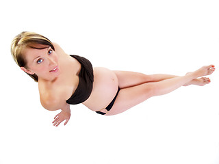 Image showing Young pregnant woman from above on white background