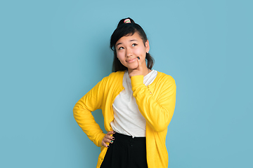 Image showing Asian teenager\'s portrait isolated on blue studio background