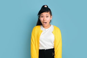 Image showing Asian teenager\'s portrait isolated on blue studio background