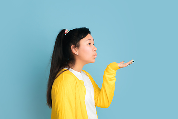 Image showing Asian teenager\'s portrait isolated on blue studio background