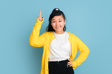 Image showing Asian teenager\'s portrait isolated on blue studio background