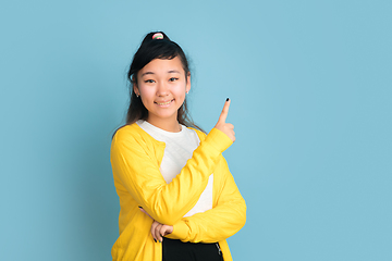 Image showing Asian teenager\'s portrait isolated on blue studio background