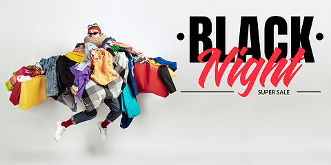 Image showing Man addicted of sales and clothes, black night, sales concept