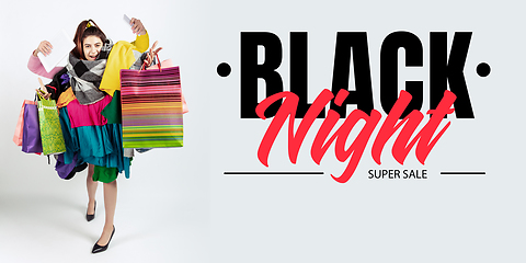 Image showing Woman addicted of sales and clothes, black night, sales concept