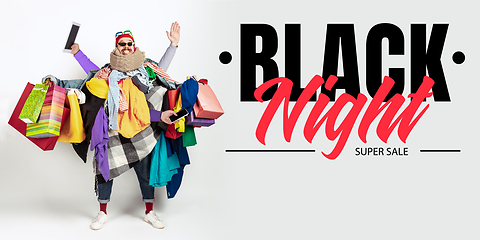 Image showing Man addicted of sales and clothes, black night, sales concept