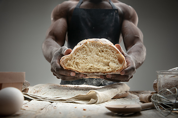 Image showing Close up of african-american man cooks bread at craft kitchen