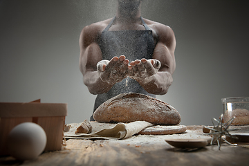 Image showing Close up of african-american man cooks bread at craft kitchen