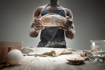 Image showing Close up of african-american man cooks bread at craft kitchen