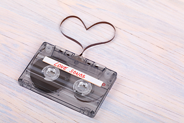 Image showing Audio cassette tape on wooden background. audio film shaping hea