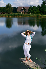 Image showing Young woman resting near lake