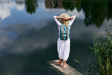 Image showing Young woman resting near lake