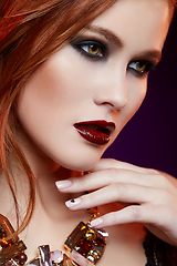 Image showing beautiful girl with bright makeup and red hair