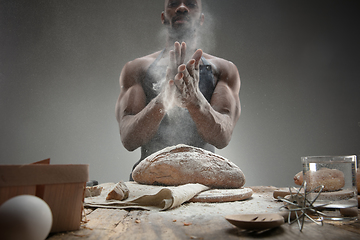 Image showing Close up of african-american man cooks bread at craft kitchen