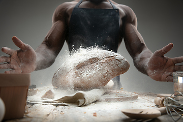 Image showing Close up of african-american man cooks bread at craft kitchen