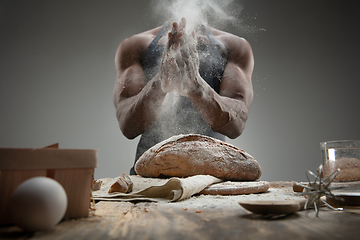 Image showing Close up of african-american man cooks bread at craft kitchen