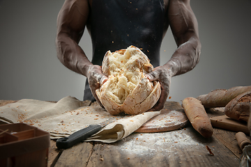 Image showing Close up of african-american man cooks bread at craft kitchen