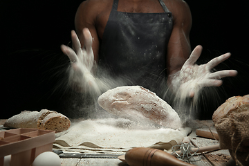 Image showing Close up of african-american man cooks bread at craft kitchen