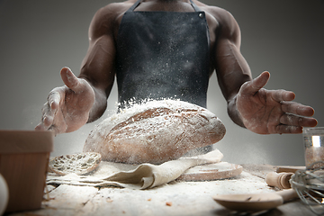 Image showing Close up of african-american man cooks bread at craft kitchen