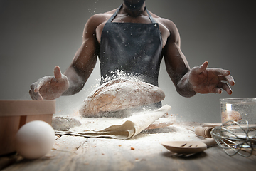 Image showing Close up of african-american man cooks bread at craft kitchen