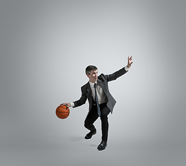 Image showing Caucasian man in office clothes training isolated on grey studio background