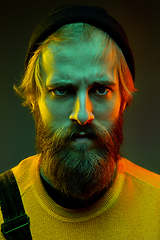 Image showing Caucasian man\'s portrait isolated on gradient studio background in neon light