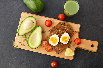 Image showing toast bread with eggs, cherry tomatoes and avocado